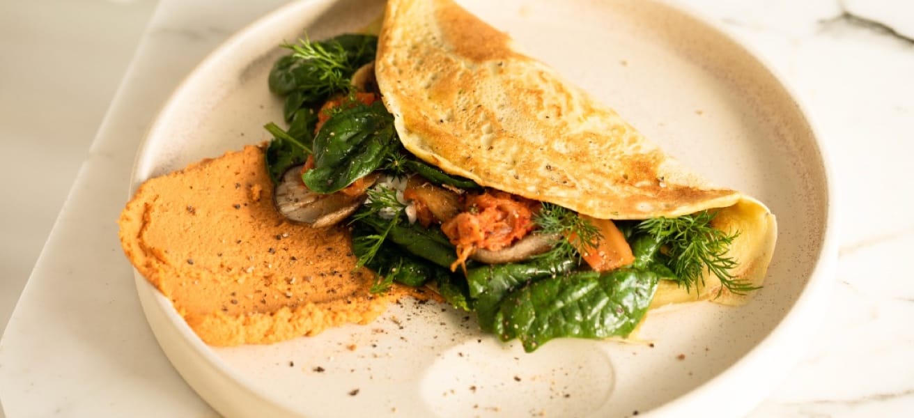 Delicious omelette on a plate with vegetables